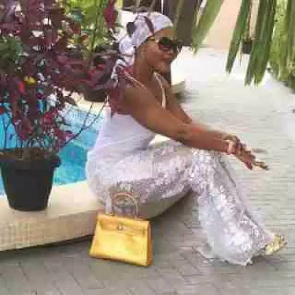 Lagos Society Lady Shows Off A Collection Of Her Expensive Handbags By Poolside